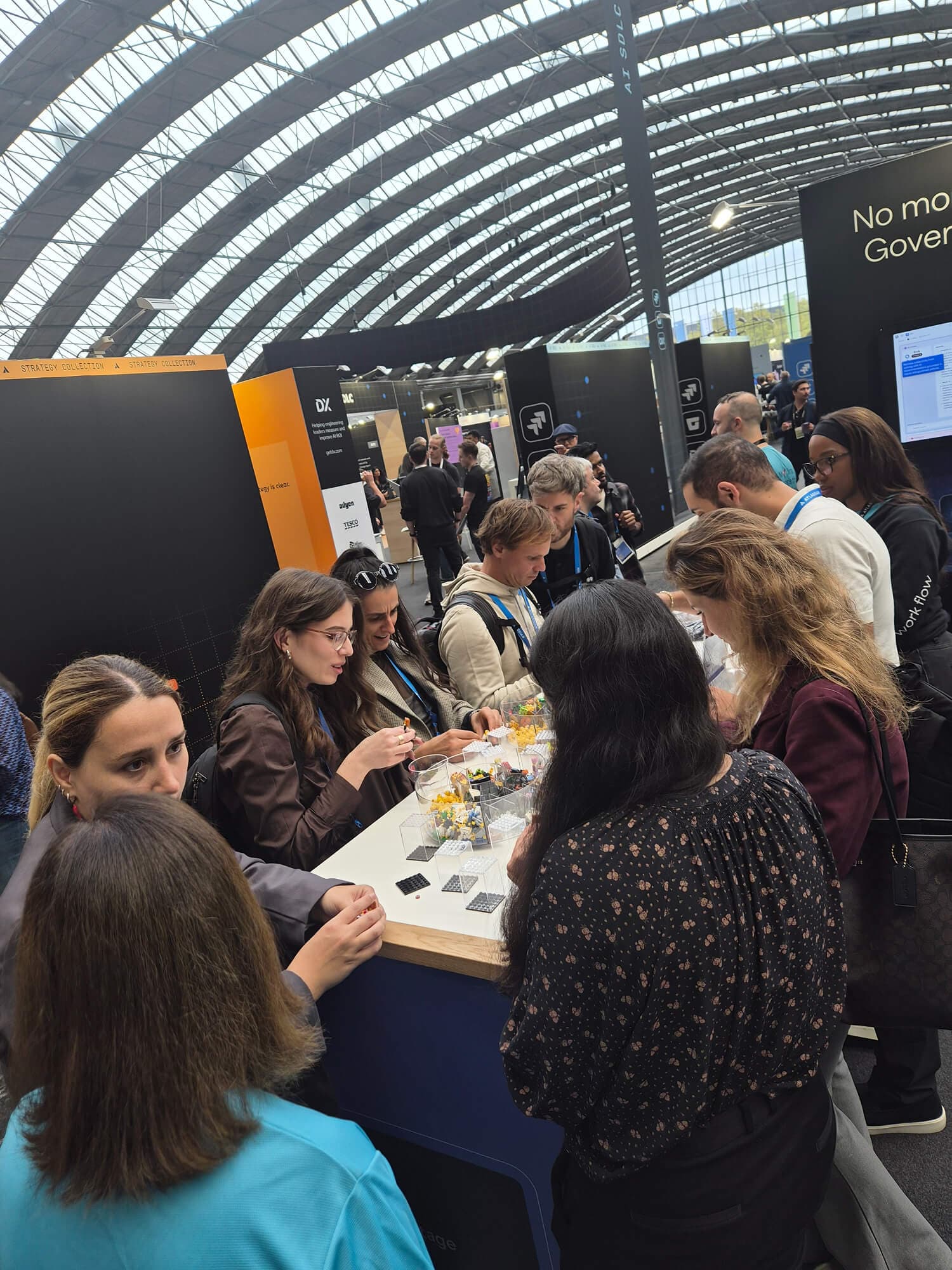 Attendees networking and participating in activities at the Appfire booth during Atlassian Team '26 Europe.