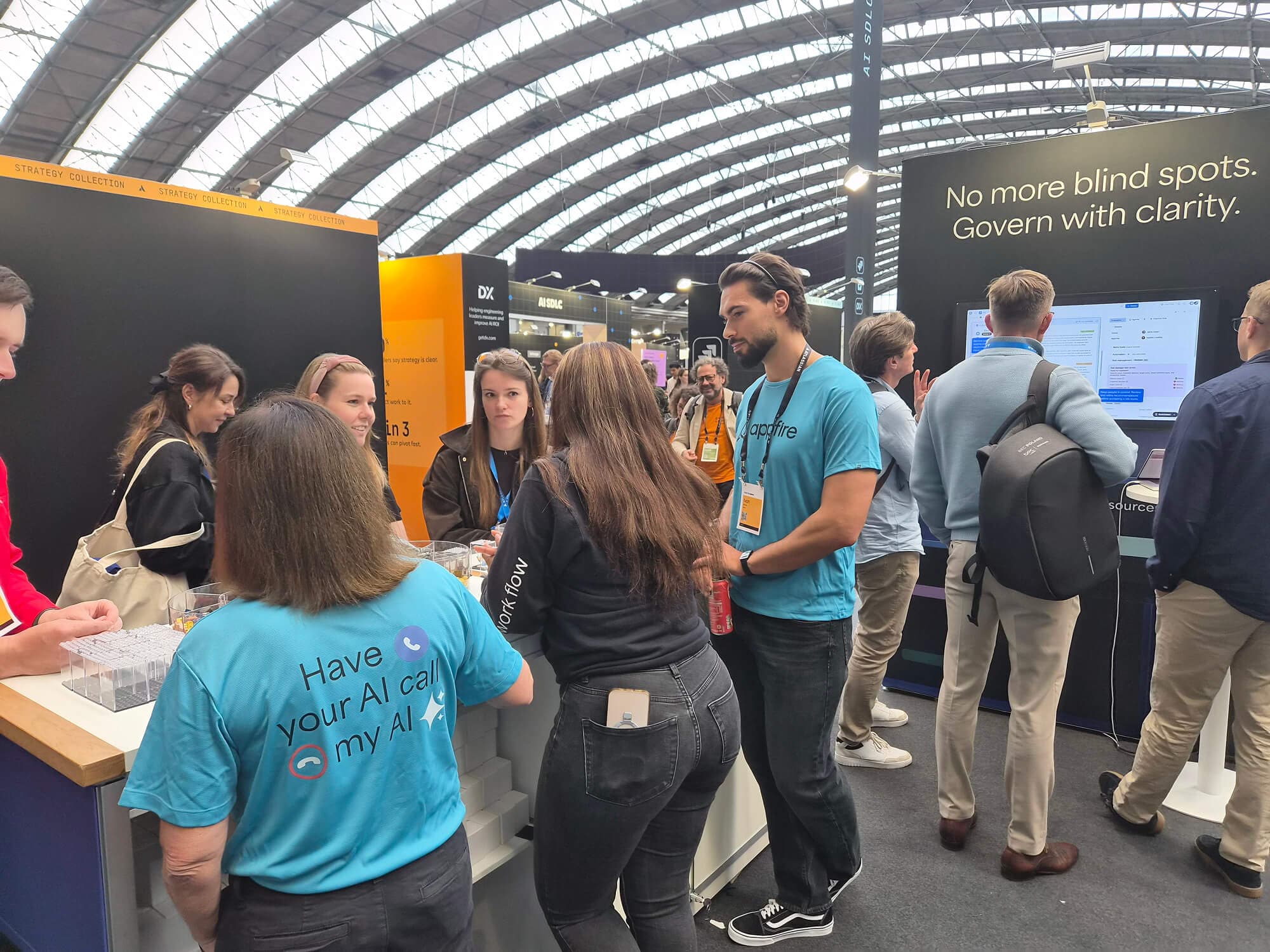 Appfire team members engaging with visitors and showcasing solutions at the Atlassian Team '26 Europe booth.