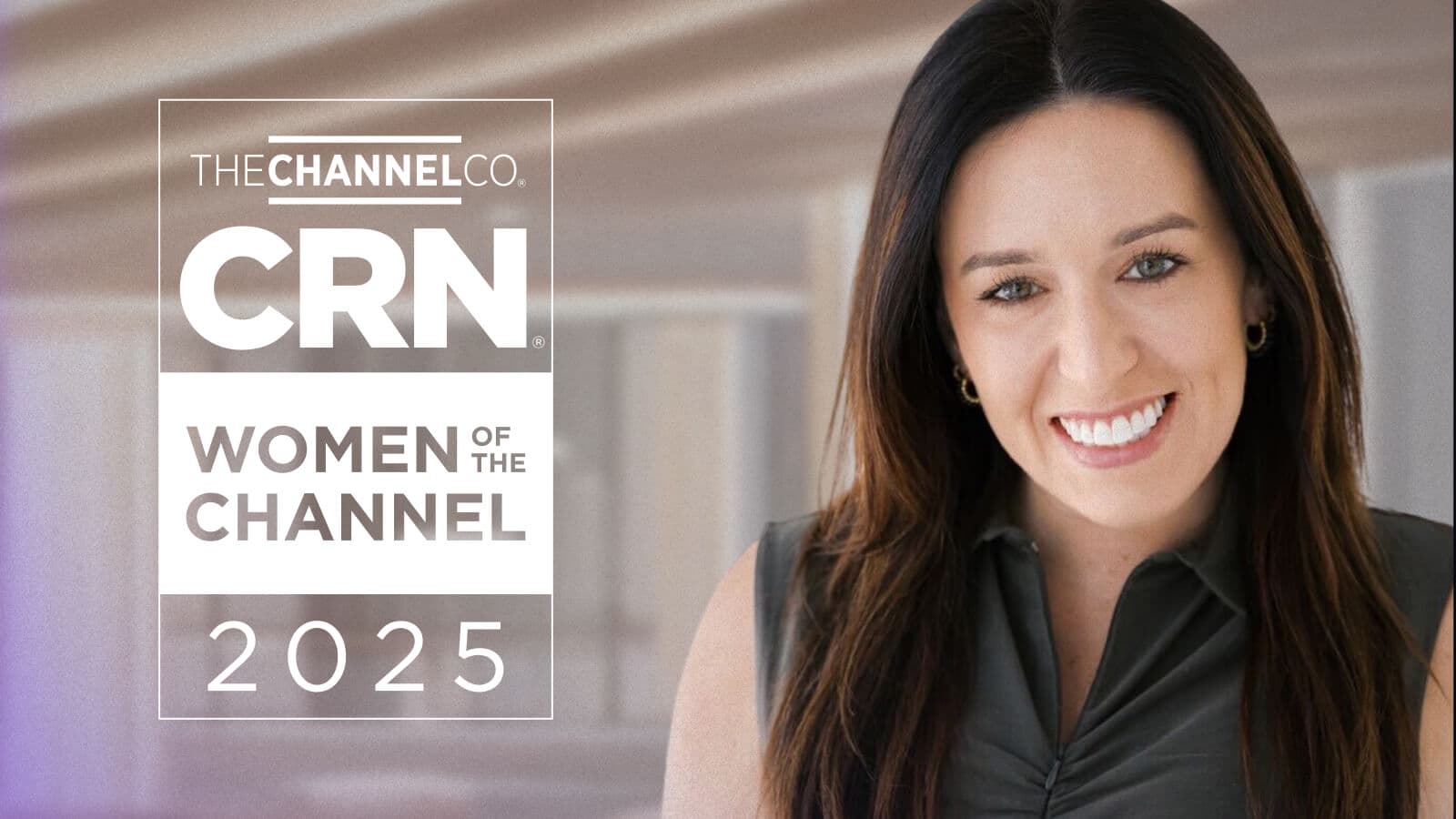 A smiling woman with long dark hair wearing a sleeveless dark top, standing in front of a softly blurred modern background. On the left side of the image is a graphic that reads: 'THE CHANNEL CO. CRN Women of the Channel 2025