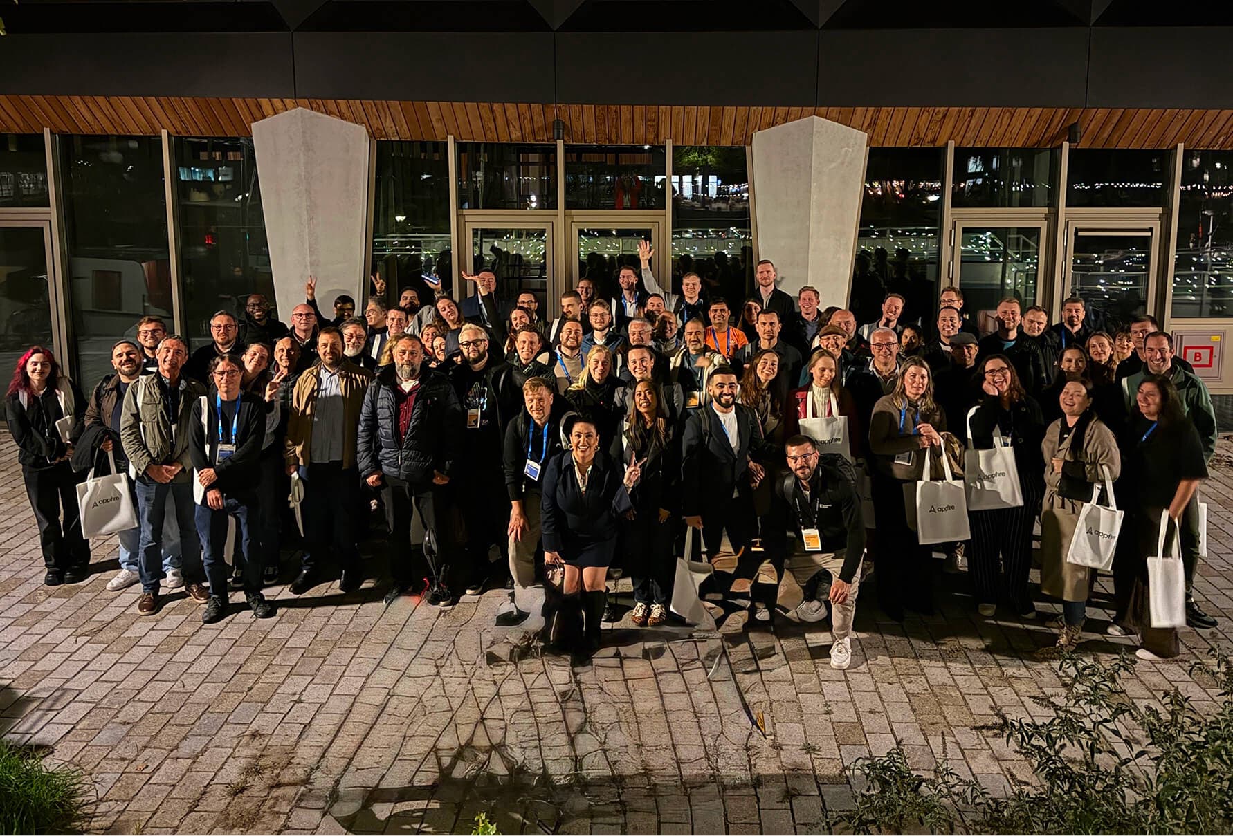 Group photo of Appfire customers and attendees at an evening networking reception during Atlassian Team '26 Europe.