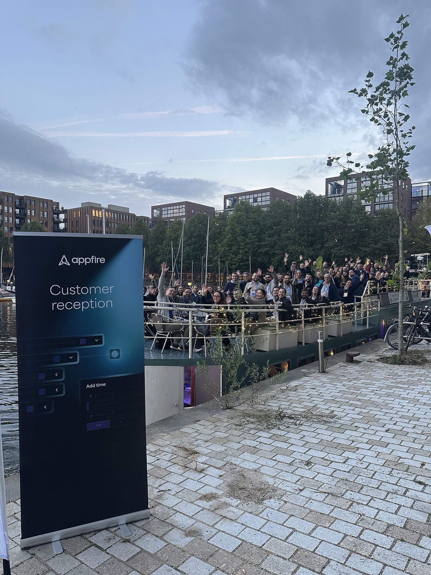 Appfire customers and attendees gathering for a waterfront customer reception in Amsterdam during Team '26 Europe.
