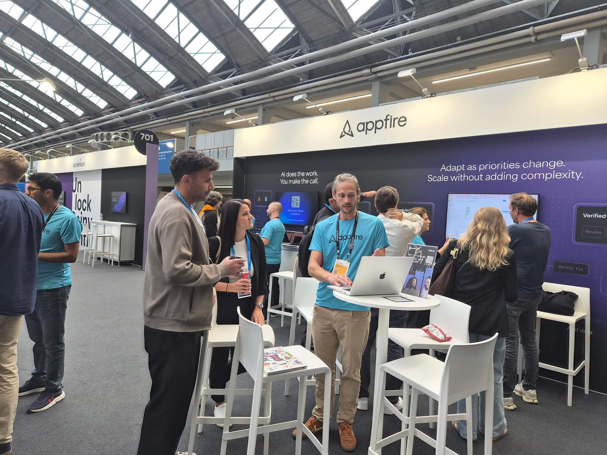 Appfire team members demonstrating products and connecting with attendees at Atlassian Team '26 Europe in Amsterdam.