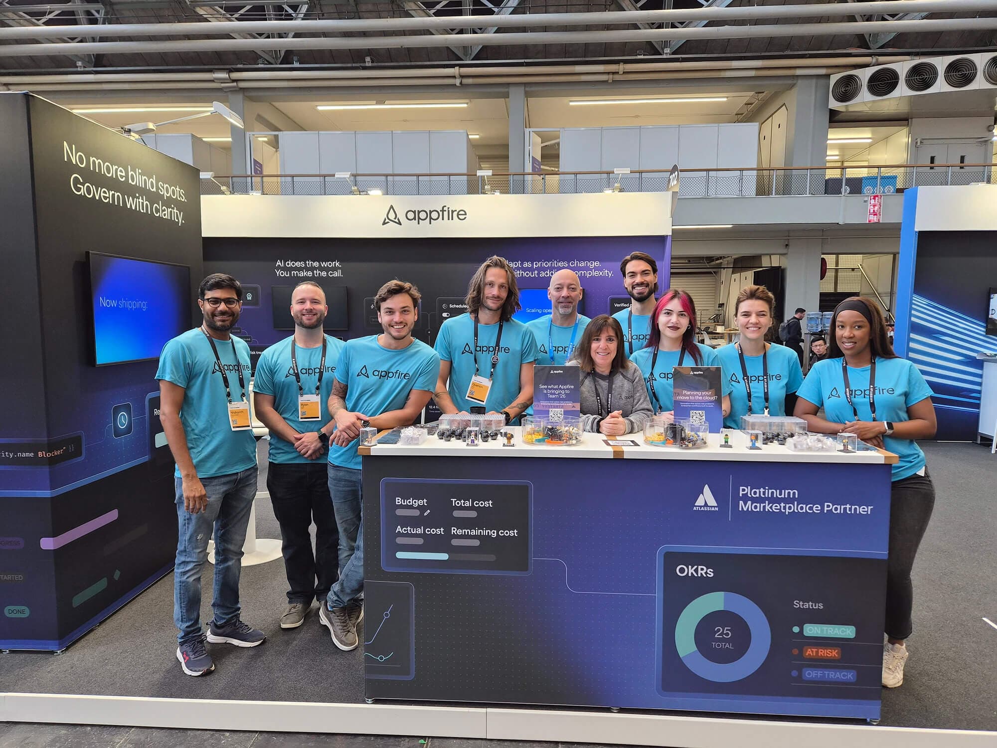 Appfire team posing together at their exhibition booth during Atlassian Team '26 Europe in Amsterdam.